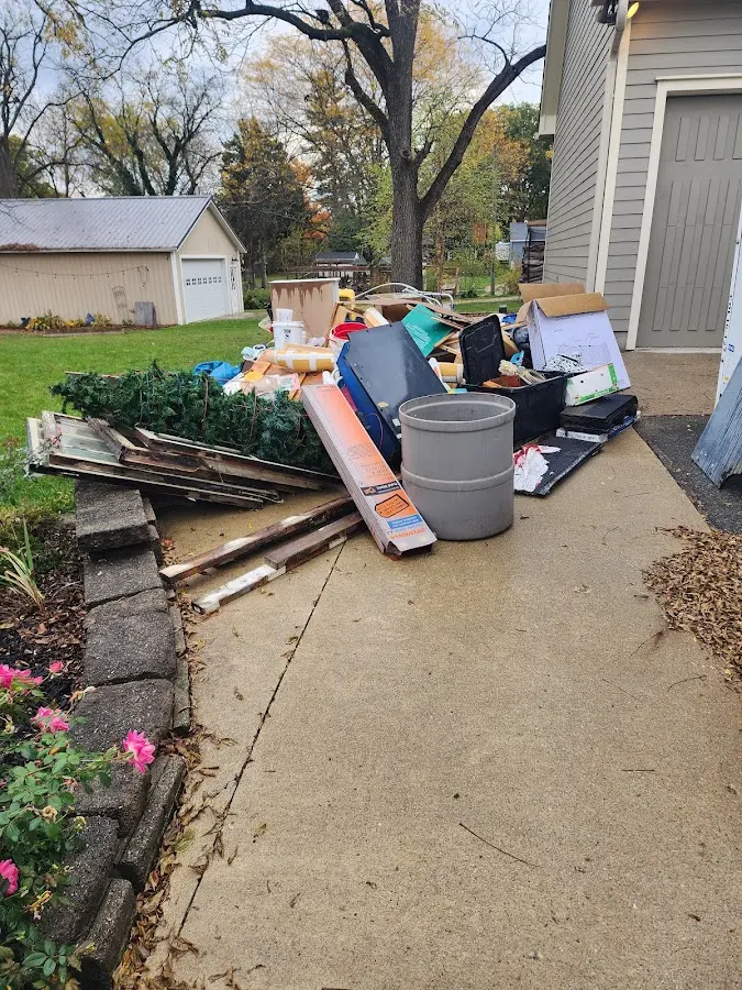 Dumpster being loaded with debris for 12 Yard Dumpster Rental in Old Jamestown